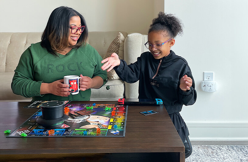 Mother and daughter are having fun in the living room.